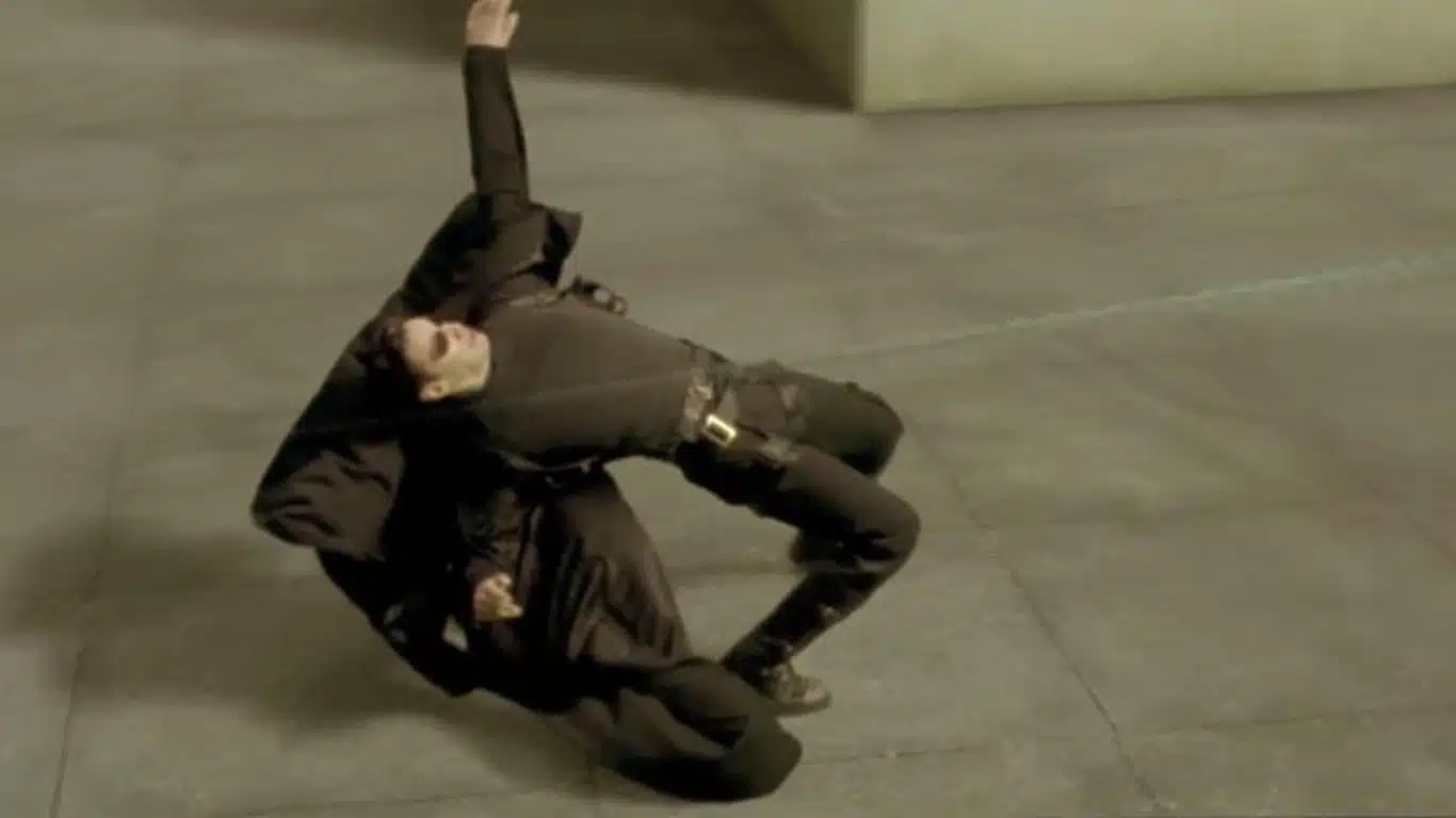 Top 10 Movie Stunts of All Time - The Matrix (1999): Bullet time and rooftop fight scene stunts