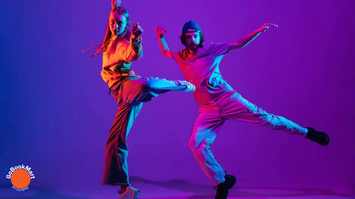 International Dance Day: Details Including Date, Historical Background, and Importance - Two dancers striking dynamic poses in colorful lighting.